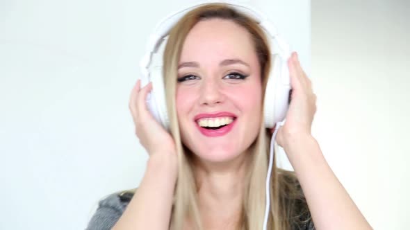 Beautiful Young Blond Woman Dancing With White Headphones 7