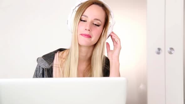 Beautiful Young Blond Woman Listening To Music On Laptop With White Headphones 2