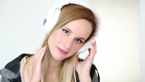 Beautiful Young Blond Woman Listening To Music On Laptop With White Headphones 6