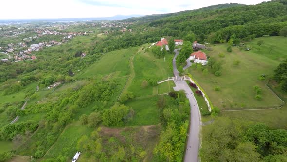 Aerial View Of Houses In Forest Of Mount Medvednica, With Cityscape In Distance. 1