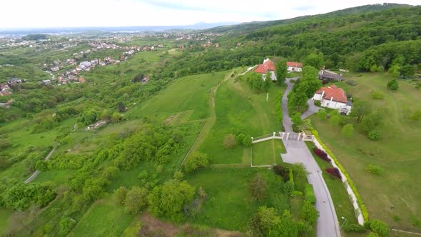 Aerial View Of Houses In Forest Of Mount Medvednica, With Cityscape In Distance. 2 alt