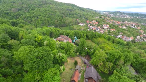 Aerial View Of Houses In Forest Of Mount Medvednica, With Cityscape In Distance. 3