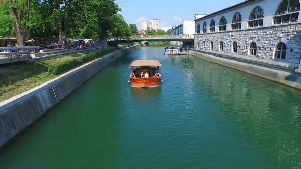 Aerial View Of Orange Boat On Green River Ljubljana, Slovenia.