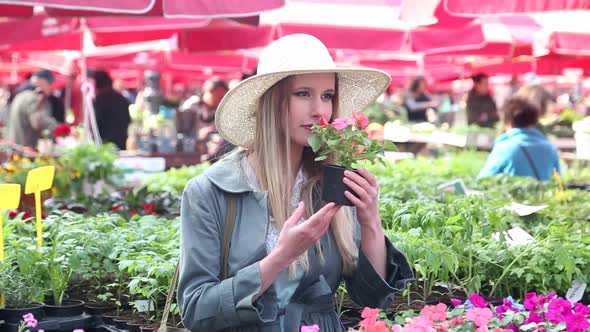 Blonde Beautiful Woman Holding Flower In The Market 2