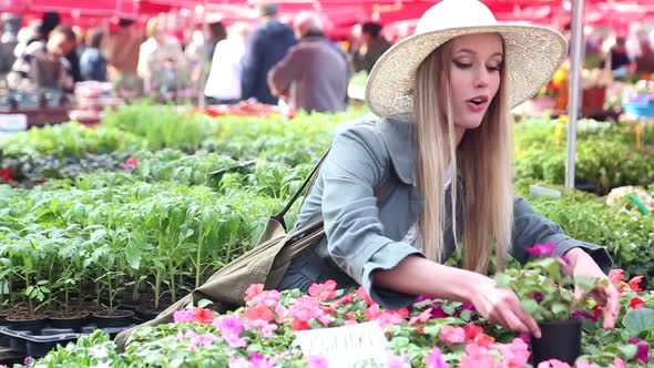 Blonde Beautiful Woman Holding Flower In The Market 3