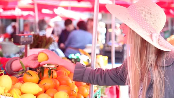Blonde Girl At The Market Picking Fruit 1