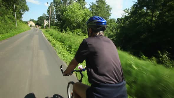 Slow Motion - Man Cycling On Road In Countryside 1