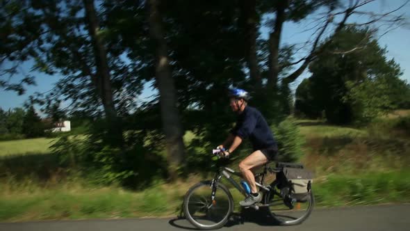 Slow Motion - Man Cycling On Road In Countryside 2 alt