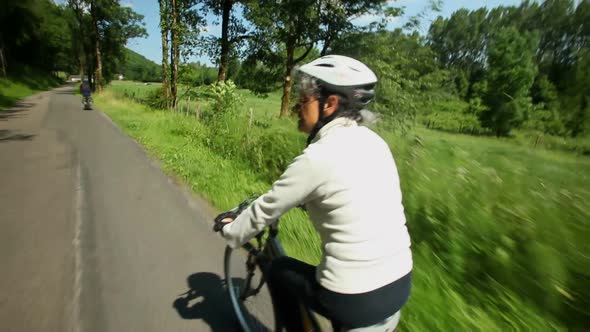 Slow Motion - Woman Cycling On Road In Countryside 2 alt