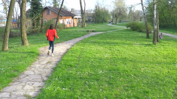 Slow Motion Of Man Running Down The Pathway In Park. 3