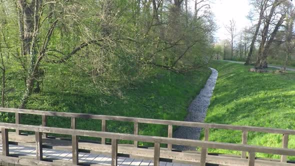 Slow Motion Of Runner Crossing A Bridge In Park. 1