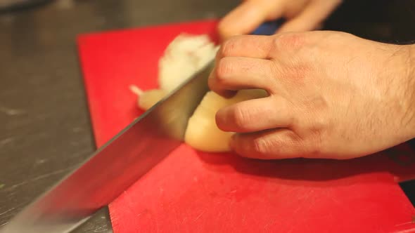 Chef Chopping Onions In Kitchen alt