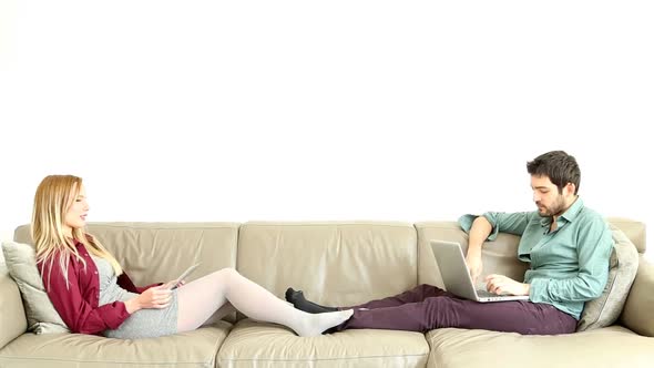 Woman Leaning On Couch Speaking To Sitting Young Man 1 alt