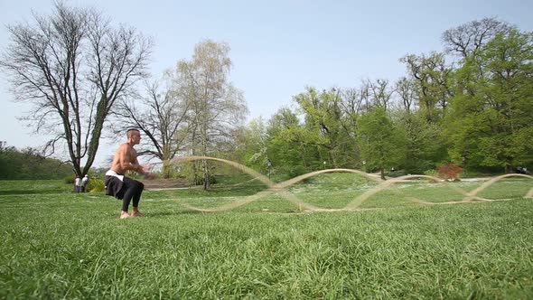 Strong Man Exercising With Ropes 1