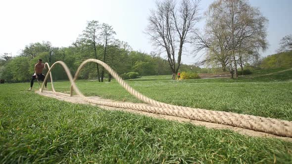 Strong Muscular Man Exercising With Ropes 2