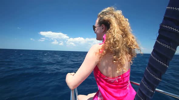 Woman Sitting On Bow Of Sailing Boat Enjoying View Of Sea 2