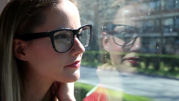 Young Blond Woman Riding Tram, Looking Out The Window 1