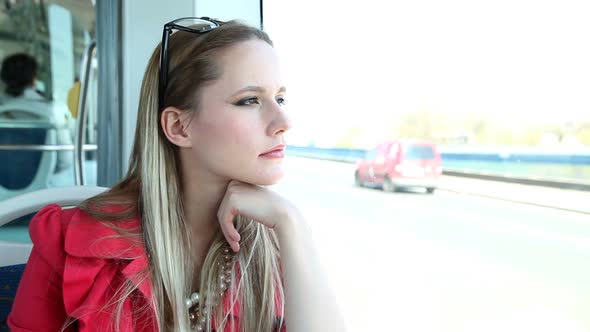 Young Blond Woman Riding Tram, Looking Out The Window 2