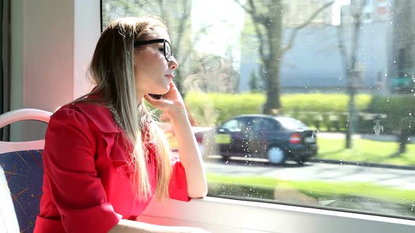 Young Blond Woman Riding Tram, Talking On Mobile, Phone, Cell 2 alt