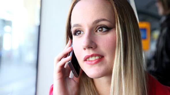 Young Blond Woman Riding Tram, Talking On Mobile, Phone, Cell And Waving