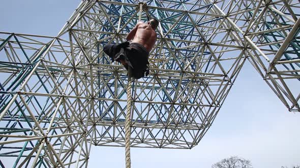 Muscular Man Is Climbing On The Rope 3