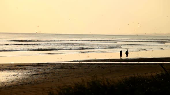 People Walking On Beach