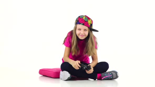 Teen with Console Playing Video Game, White Background. Slow Motion alt