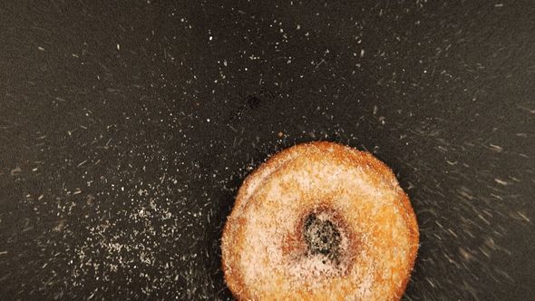 Doughnut Falls On A Black Desk