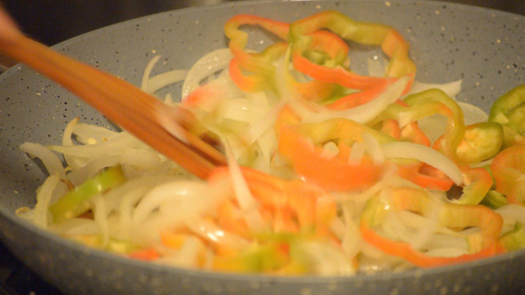 Onions And Bell Peppers On A Hot Pan