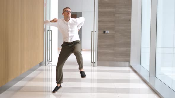 Funny Businessman Dancing In Airpods Near Office