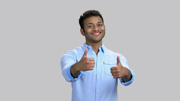 Portrait of Cheerful Happy Darkskinned Man Shows Both Thumbs Up