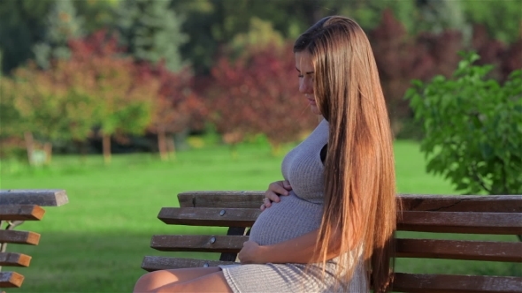 Pregnant Woman Resting On a Bench