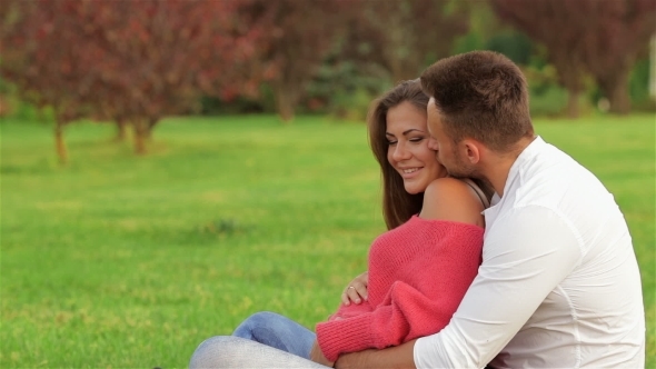 Couple Sitting On The Grass