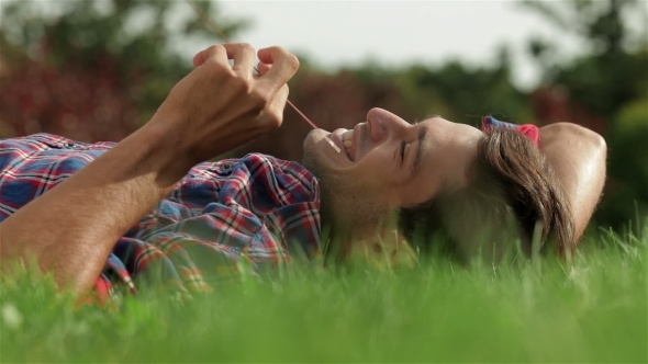 Handsome Male Student On a Green Grass