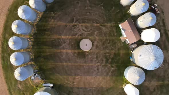 Fast ascending aerial shot on a family operated farm in Canadian prairie setting. Young man remote c