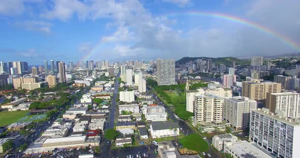 Aerial view over Honolulu rising up and panning across the cityscape