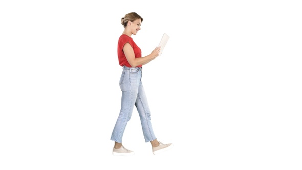 Happy woman walking with tablet on white background.