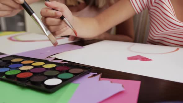 Mother and daughters painting together