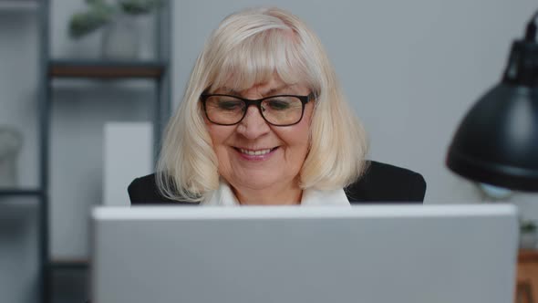 Senior Businesswoman Wears Glasses Working at Home Office Online Webinar Using Laptop Computer