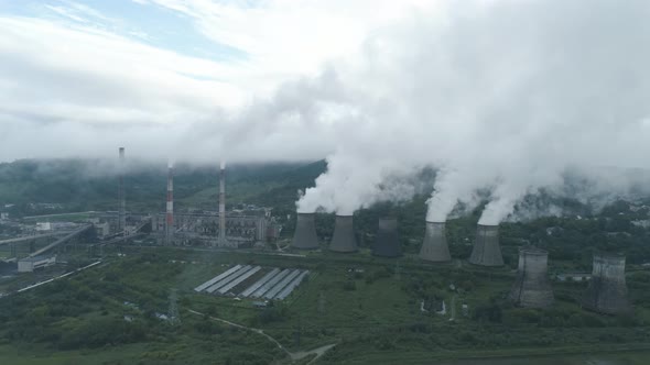 Aerial Drone View of Smoking Pipes and Cooling Towers of Coal Thermal Power Plant