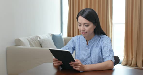 Woman use of tablet computer at home