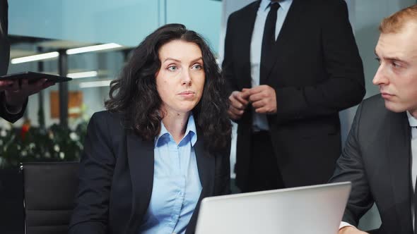 Female CEO Talking to Business Team at Meeting