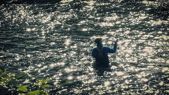 Fisherman Fly Fishing In Sparkling Evening River