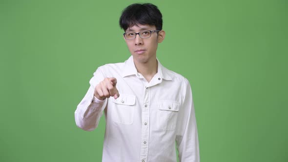 Young Asian Businessman Pointing To Camera