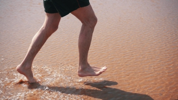 Man Running On Beach