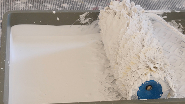 Pouring White Paint Into The Tray