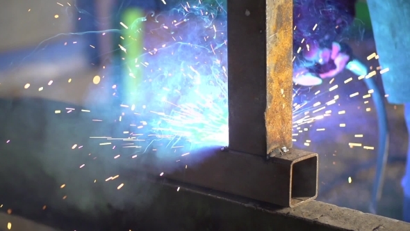 Workers Grinding And Welding In a Factory