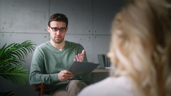 Professional psychiatrist interviewing a young girl