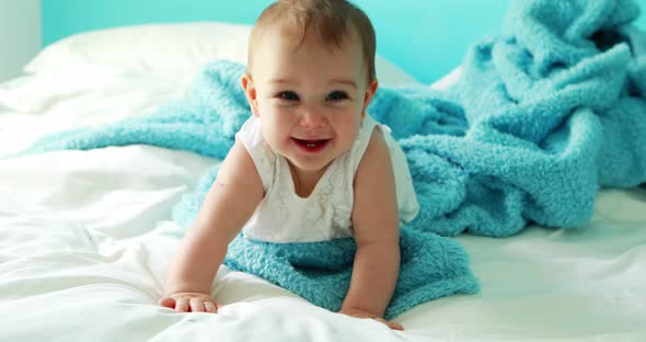 Cute baby girl playing on bed