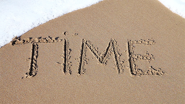 Word "Time" Drawn In The Sand